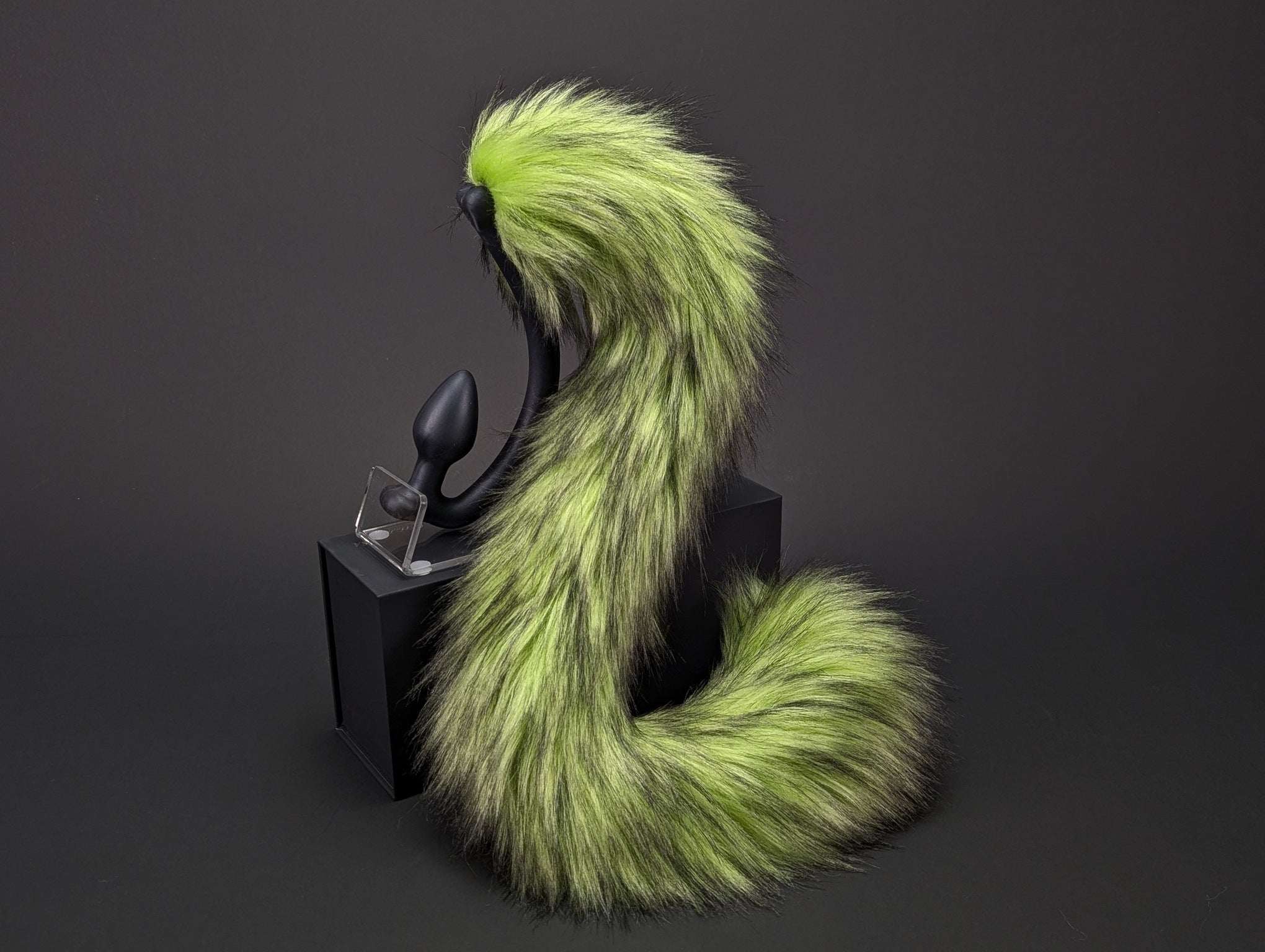 toxic-cat-tail cat tail butt plug in green and lime with realistic faux fur tail and raised tail design