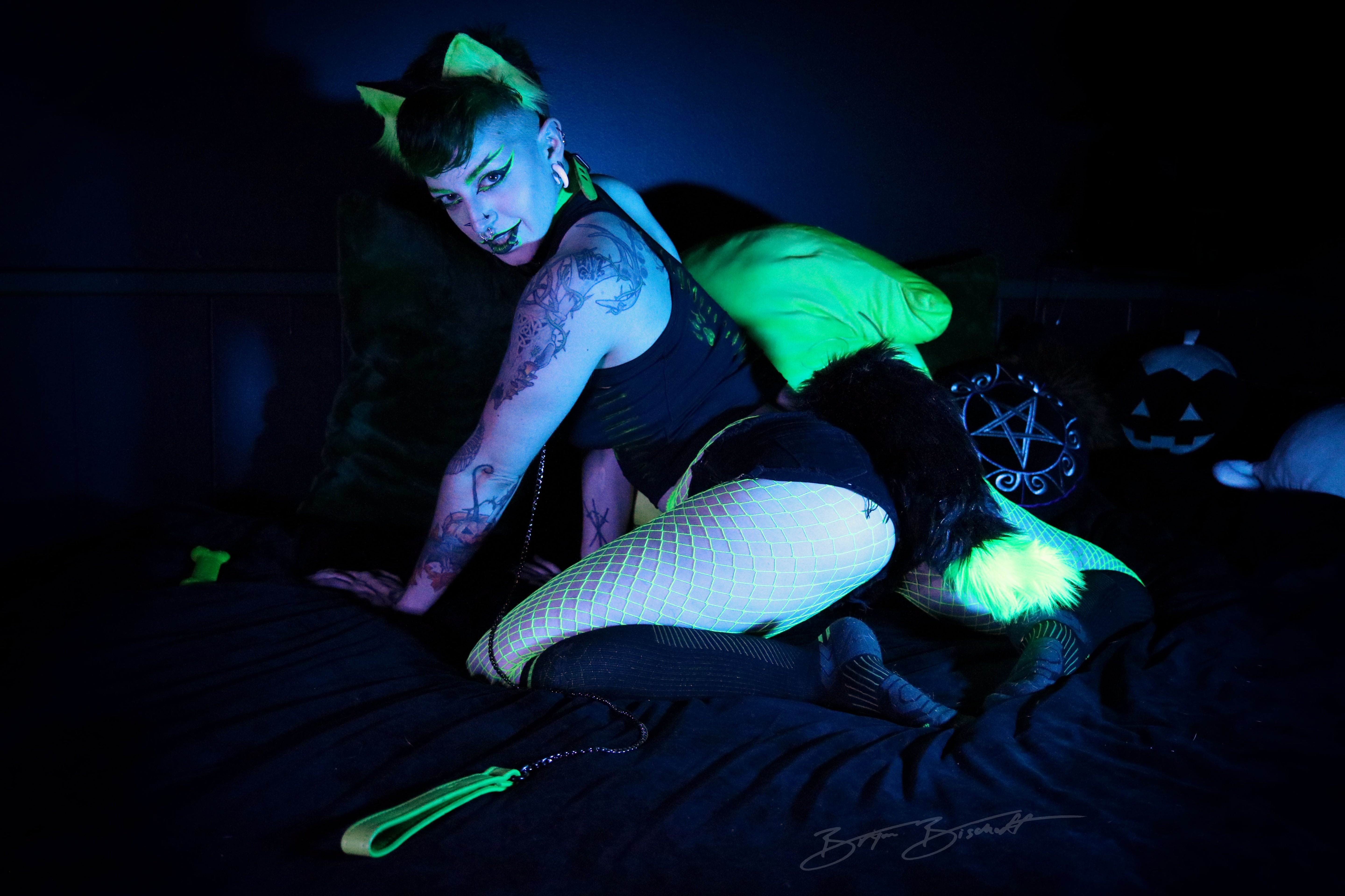 Person wearing black and green fox tail