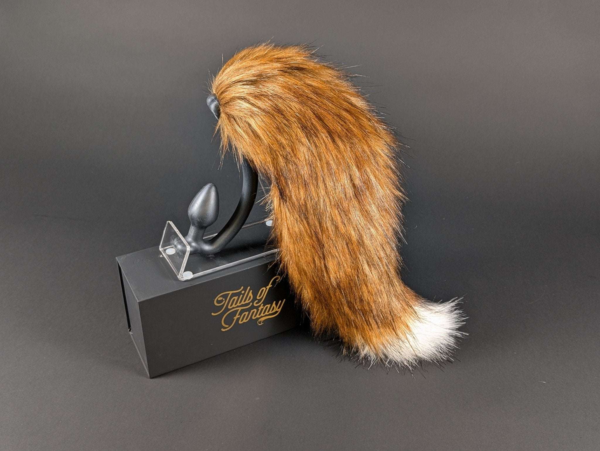 A very fancy fox tail, burnt red in color